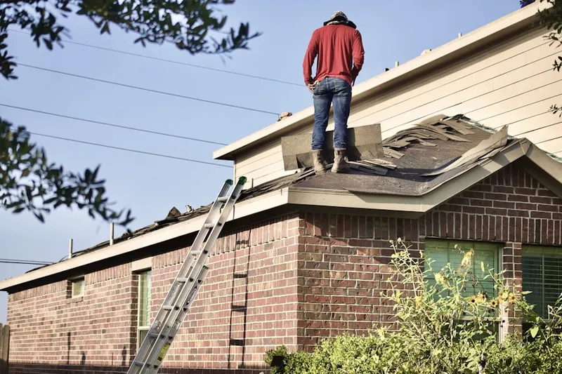 Professional roofer working on a residential roof in Abby Trails